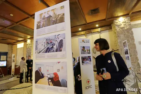 Palestinians participate in a photo gallery organized by Red cross (ICRC) on the occasion of over 50 years of its presence in the occupied Palestinian territories, in Gaza city on June 13, 2017. Photo by Ashraf Amra