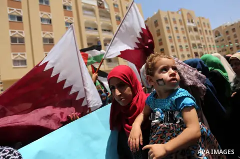 Palestinian women take part in a rally in support of Qatar, inside Qatari-funded construction project 'Hamad City', in Khan Younis in the southern Gaza Strip, June 14, 2017. Photo by Ashraf Amra