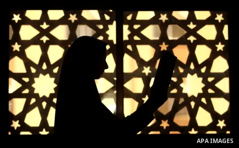A Palestinian girl holds a copy of the Koran, Islam's holiest book, on the Muslim holy fasting month of Ramadan, at Hamad Mosque in Khan Younis in the southern Gaza Strip, June 14, 2017. Ramadan is sacred to Muslims beca...