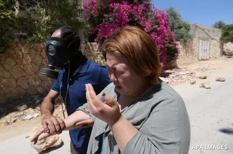 A Palestinian woman is evacuated after inhaling tear gas fired by fired by Israeli forces during clashes following a demonstration against the expropriation of Palestinian land by Israel in the village of Kfar Qaddum, ne...