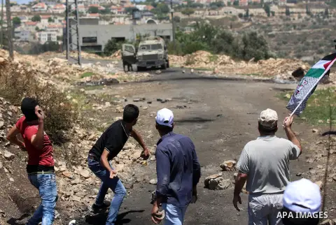 Palestinian protesters hurl stones towards Israeli security forces during clashes following a demonstration against the expropriation of Palestinian land by Israel in the village of Kfar Qaddum, near Nablus, in the occup...