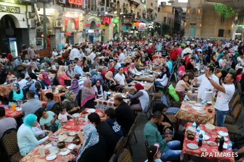 Egyptian muslims take their breakfast during the holy fasting month of Ramadan in front of al-Hussein mosque at Al-Azhar district in old Islamic Cairo, Egypt, on June 17, 2017. Ramadan is sacred to Muslims because it is...