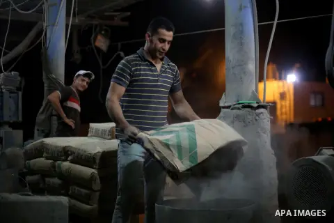Palestinian labourers work at a cement factory at night, to avoid the day time heat, on the Muslim holy fasting month of Ramadan in Gaza city on June 17, 2017. Ramadan is sacred to Muslims because it is during that month...