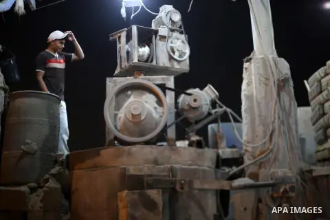 A Palestinian labourer works at a cement factory at night, to avoid the day time heat, on the Muslim holy fasting month of Ramadan in Gaza city on June 17, 2017. Ramadan is sacred to Muslims because it is during that mon...