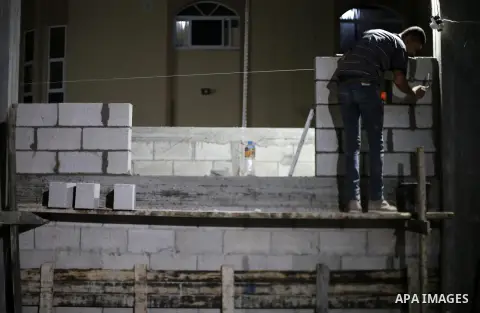 A Palestinian labourer works at construction site at night, to avoid the day time heat, on the Muslim holy fasting month of Ramadan in Gaza city on June 17, 2017. Ramadan is sacred to Muslims because it is during that mo...