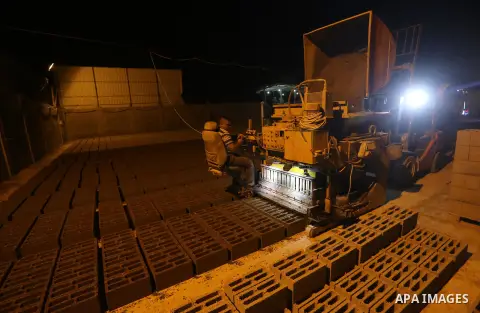 A Palestinian labourer works at a cement factory at night, to avoid the day time heat, on the Muslim holy fasting month of Ramadan in Gaza city on June 17, 2017. Ramadan is sacred to Muslims because it is during that mon...