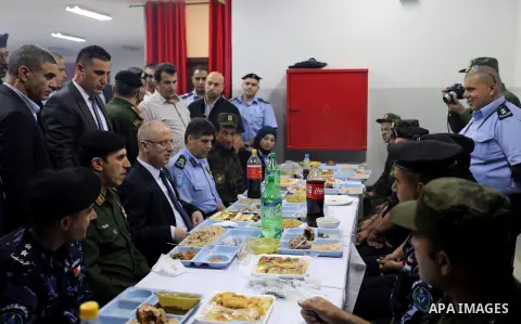 Palestinian Prime Minister Rami Hamdallah takes part in breakfast with security forces on the Muslim holy fasting month of Ramadan, in the West Bank city of Jenin on June 18, 2017. Photo by Prime Minister Office