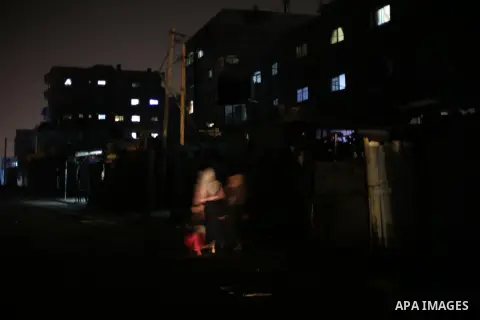 A general view shows Gaza City in the evening hours during a power cut, on June 19, 2017. Photo by Mohammed Asad