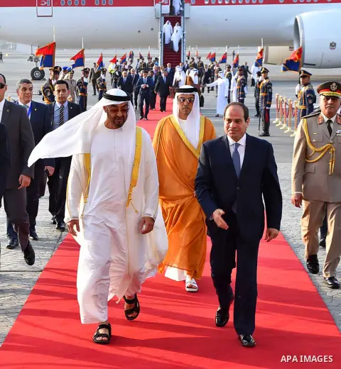 Egyptian President Abdel Fattah al-Sis walks with Abu Dhabi Crown Prince Sheikh Mohammed bin Zayed al-Nahyan after he arrives in Cairo International Airport on June 19, 2017. Photo by Egyptian President Office