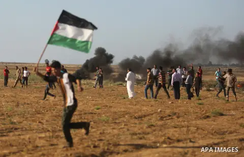 Palestinians react to tear gas fired by Israeli troops during clashes at a protest against reducing power supply to Gaza, near the border with Israel in Khan Younis in the southern Gaza Strip June 20, 2017. Photo by Ashr...
