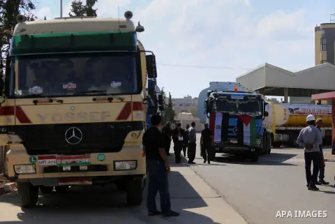Palestinian policemen keep guard as tankers exit Gaza's power plant in Nuseirat in the center of Gaza strip on June 21, 2017. Egypt began to deliver a million litres of fuel to Gaza, temporarily easing a crisis that has...