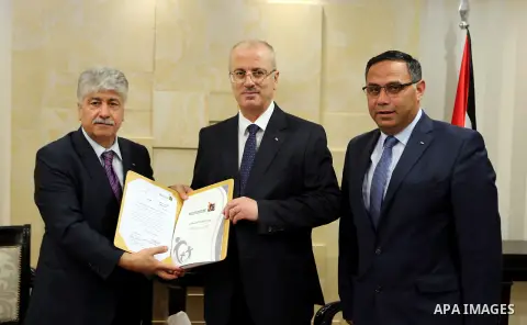 Palestinian Prime Minister Rami Hamdallah receives report of the Palestinian retirement Authority for 2016, at his office in the West Bank city of Ramallah on June 22, 2017. Photo by Prime Minister Office