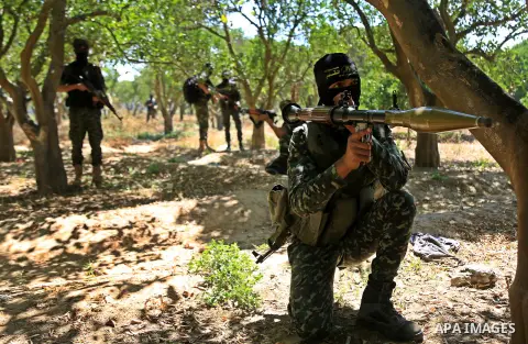 Palestinian militants from the Al-Quds Brigades, the armed wing of the Islamic Jihad movement guard the border in the east of Gaza city on the Muslim holy fasting month of Ramadan on June 22, 2017. Ramadan is sacred to M...