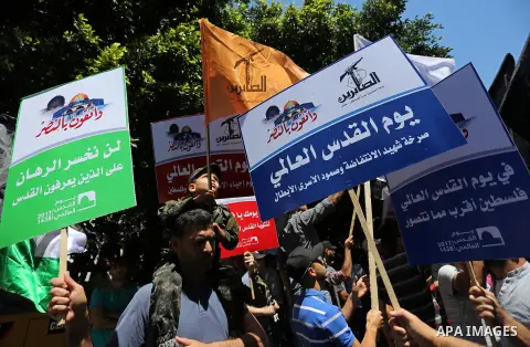 Palestinians take part in a protest marking the annual al-Quds Day, or Jerusalem Day, following Friday prayer in Gaza city June 23, 2017. Photo by Ashraf Amra