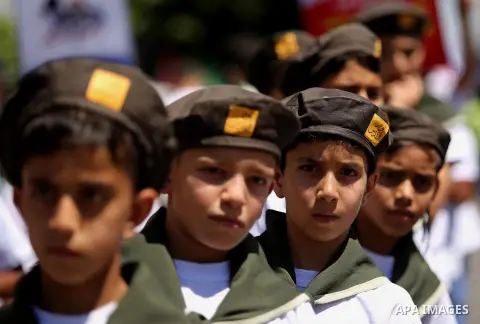 Palestinian Scout youths take part in a protest marking the annual al-Quds Day, or Jerusalem Day, following Friday prayer in Gaza city June 23, 2017. Photo by Ashraf Amra