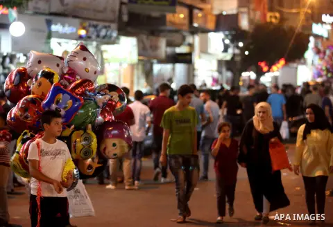Palestinians shop at a market a few days ahead of Eid al-Fitr holiday, in the West Bank city of Nablus on June 23, 2017. Eid al-Fitr marks the end of Muslim's holy fasting month of Ramadan when faithfuls abstain from eat...