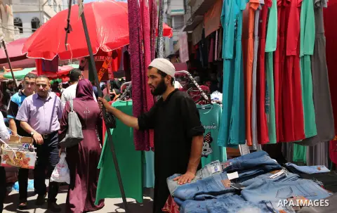 Palestinians shop at a market ahead of Eid al-Fitr holiday, in Gaza city on June 24, 2017. Eid al-Fitr marks the end of Muslim's holy fasting month of Ramadan when faithfuls abstain from eating, drinking, smoking and sex...