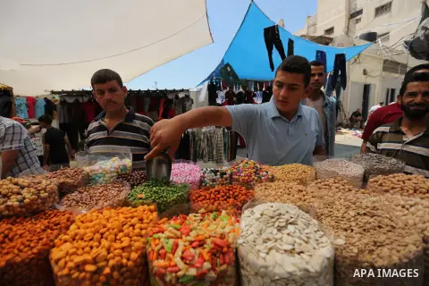 A Palestinian vendor sells nuts at a market ahead of Eid al-Fitr holiday, in Gaza city on June 24, 2017. Eid al-Fitr marks the end of Muslim's holy fasting month of Ramadan when faithfuls abstain from eating, drinking, s...