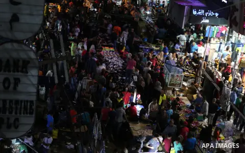 Palestinians shop at a market ahead of Eid al-Fitr holiday, in Gaza city on June 24, 2017. Eid al-Fitr marks the end of Muslim's holy fasting month of Ramadan when faithfuls abstain from eating, drinking, smoking and sex...