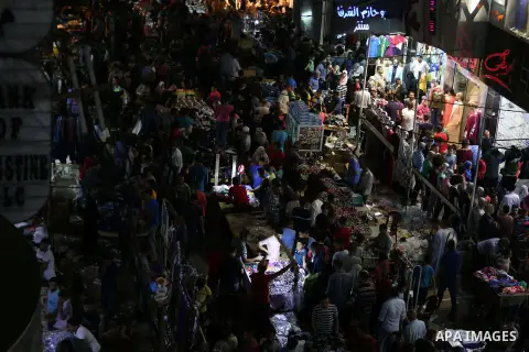Palestinians shop at a market ahead of Eid al-Fitr holiday, in Gaza city on June 24, 2017. Eid al-Fitr marks the end of Muslim's holy fasting month of Ramadan when faithfuls abstain from eating, drinking, smoking and sex...