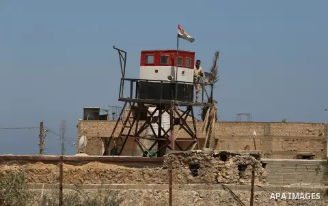 An Egyptian border stands guard on the border with Egypt, in the southern Gaza strip town of Rafah, on June 29, 2017. The buffer zone is expected to extend for a length of 12 kilometres and at a width of 100 metres along...