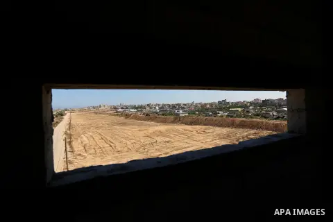 Parliment Palestinian bulldozers clear an area as Hamas begins creating a large buffer zone on the border with Egypt in the southern Gaza strip town of Rafah, on June 29, 2017. The buffer zone is expected to extend for a...