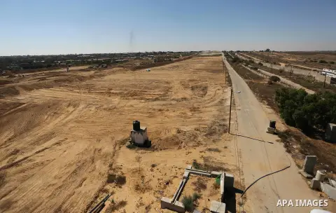 Parliment Palestinian bulldozers clear an area as Hamas begins creating a large buffer zone on the border with Egypt in the southern Gaza strip town of Rafah, on June 29, 2017. The buffer zone is expected to extend for a...