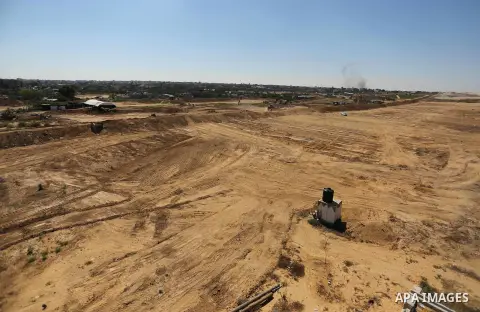 Parliment Palestinian bulldozers clear an area as Hamas begins creating a large buffer zone on the border with Egypt in the southern Gaza strip town of Rafah, on June 29, 2017. The buffer zone is expected to extend for a...