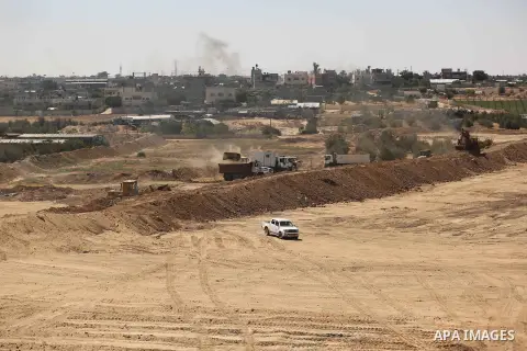 Parliment Palestinian bulldozers clear an area as Hamas begins creating a large buffer zone on the border with Egypt in the southern Gaza strip town of Rafah, on June 29, 2017. The buffer zone is expected to extend for a...