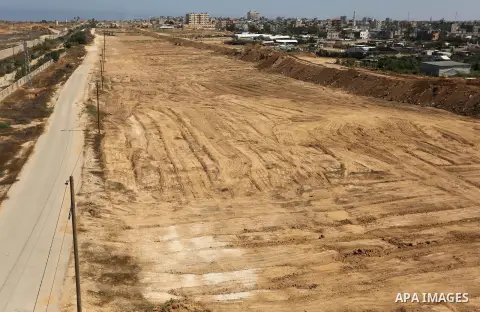 Parliment Palestinian bulldozers clear an area as Hamas begins creating a large buffer zone on the border with Egypt in the southern Gaza strip town of Rafah, on June 29, 2017. The buffer zone is expected to extend for a...