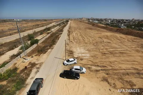 Parliment Palestinian bulldozers clear an area as Hamas begins creating a large buffer zone on the border with Egypt in the southern Gaza strip town of Rafah, on June 29, 2017. The buffer zone is expected to extend for a...
