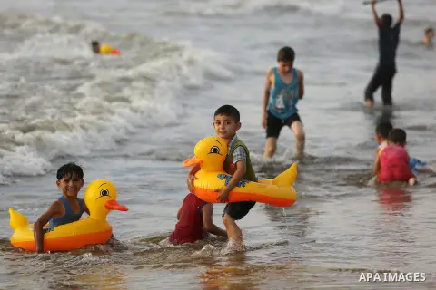 Palestinians enjoy their time at the beach of the Mediterranean sea on the coast of Gaza city, on June 30, 2017. Photo by Ashraf Amra