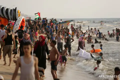 Palestinians enjoy their time at the beach of the Mediterranean sea on the coast of Gaza city, on June 30, 2017. Photo by Ashraf Amra