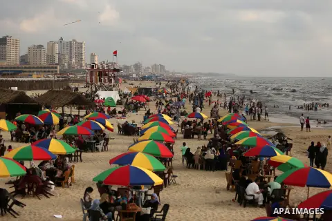 Palestinians enjoy their time at the beach of the Mediterranean sea on the coast of Gaza city, on June 30, 2017. Photo by Ashraf Amra