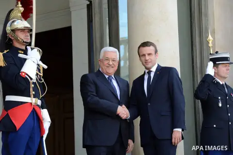 French President Emmanuel Macron shakes hands with Palestinian President Mahmoud Abbas, before their meeting at the Elysee Palace in Paris, on July 5, 2017. Photo by Thaer Ganaim