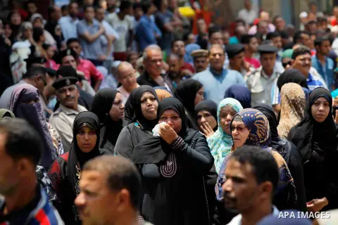 Egyptian relatives react during the funeral of officer Khaled al-Maghrabi, who was killed during a suicide bomb attack on an army checkpoint in Sinai, in his hometown Toukh, Al Qalyubia Governorate, north of Cairo, Egypt...