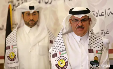 Qatar's Ambassador to the Palestinian Authority, Mohammed Al Emadi, delivers financial payments to the project to repair the homes of poor families, in Gaza city on July 10, 2017. Photo by Ashraf Amra