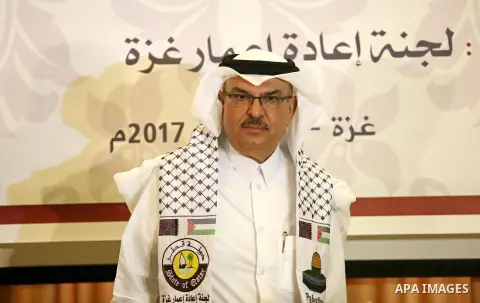 Qatar's Ambassador to the Palestinian Authority, Mohammed Al Emadi, delivers financial payments to the project to repair the homes of poor families, in Gaza city on July 10, 2017. Photo by Ashraf Amra