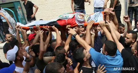 Palestinian mourners carry the body of 21-year-old Saad Salah during a funeral for Saad and 17-year-old Aws Salame, who were shot dead during clashes with the Israeli security forces in the West Bank city of Jenin, on Ju...