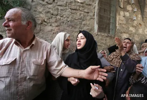 Relatives of 21-year-old Saad Salah mourn during the funeral of Saad and 17-year-old Aws Salame, who were shot dead during clashes with the Israeli security forces in the West Bank city of Jenin, on July 12, 2017. Photo...