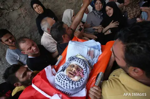 Palestinian mourners carry the body of 21-year-old Saad Salah during a funeral for Saad and 17-year-old Aws Salame, who were shot dead during clashes with the Israeli security forces in the West Bank city of Jenin, on Ju...