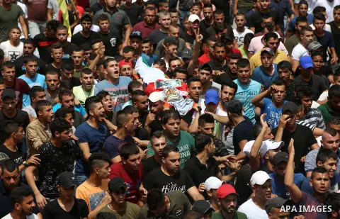 Palestinian mourners carry the body of 21-year-old Saad Salah during a funeral for Saad and 17-year-old Aws Salame, who were shot dead during clashes with the Israeli security forces in the West Bank city of Jenin, on Ju...