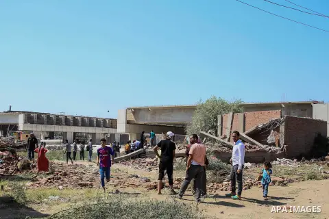 Egyptians gather during the operations of removal of illegal buildings which built on the state lands in the Warraq district of Giza, southwest of Cairo, Egypt, on July 16, 2017. Photo by Amr Sayed