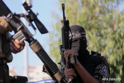 Palestinian militants from different local factions hold their weapons during a press conference to refuse closure of the Al-Aqsa Mosque compound by Israel in Gaza City on July 18, 2017. Photo by Mohammed Asad