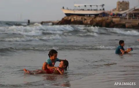 Palestinians swim in the Mediterranean sea on the coast of Gaza city on July 19, 2017. Photo by Yasser Qudih
