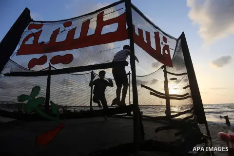 Palestinians enjoy their time at the beach of the Mediterranean sea on the coast of Gaza city on July 19, 2017. Photo by Yasser Qudih