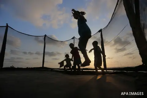 Palestinians enjoy their time at the beach of the Mediterranean sea on the coast of Gaza city on July 19, 2017. Photo by Yasser Qudih