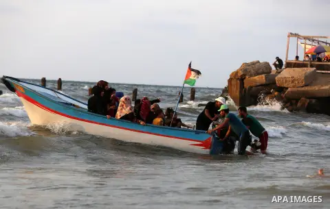 Palestinians ride their boat in the Mediterranean sea on the coast of Gaza city on July 19, 2017. Photo by Yasser Qudih