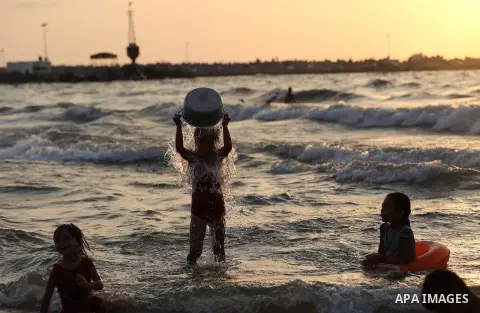 Palestinians swim in the Mediterranean sea on the coast of Gaza city on July 19, 2017. Photo by Yasser Qudih