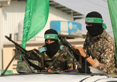 Palestinian Hamas militants take part in a military show against Israel's newly-installed security measures at the entrance to the al-Aqsa mosque compound, in Khan Younis, in the southern Gaza Strip July 20, 2017. Photo...